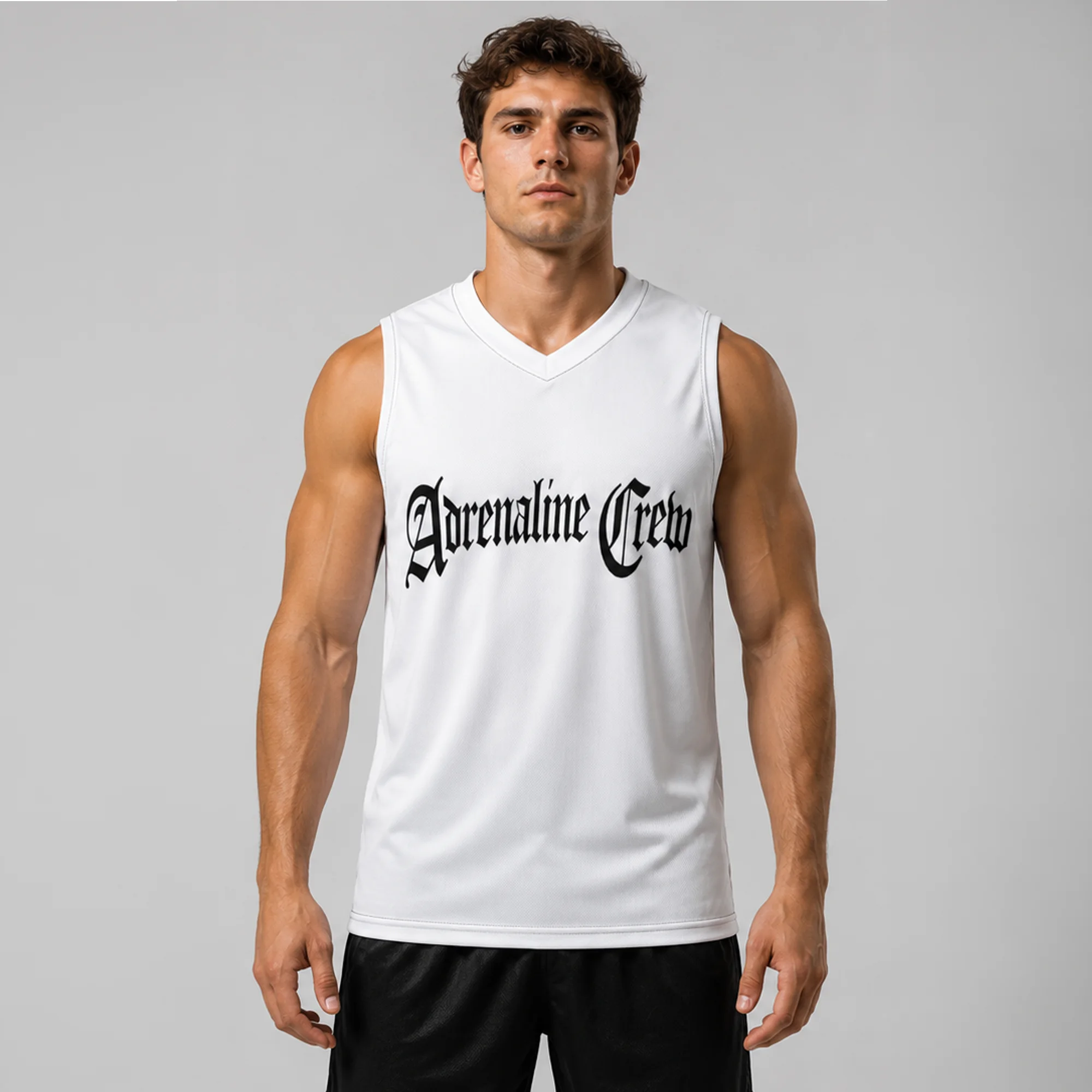 Male model wearing a white Adrenaline Crew sleeveless jersey with black logo and black shorts